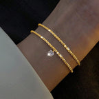 Kultainen ja hopeinen strassirannekoru naisille